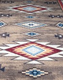 Navajo-inspired Bow Strings Brown Rug with red, blue, and light and dark brown patterns, made of UV fade, stain, and moisture-resistant EnduraStran nylon, American-made