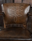 brown leather barstool with boot stitch design on back