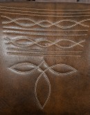 brown leather barstool with boot stitch design on back