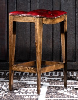 saddle stool with tufted red leather seat cushion