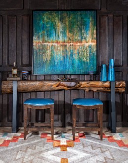 An image showcasing the Levi Saddle Stool, a masterpiece of American craftsmanship. The stool features a denim blue aniline dyed full grain leather seat, lightly sanded for a distressed look. Its clean-lined design boasts solid Alder Wood straight legs, r