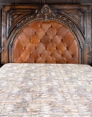 spanish style wood bed with tufted leather headboard