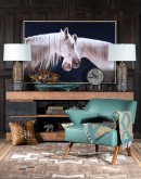 Art piece 'Mirrored Beauty,' depicting two white horses crossing necks against a black background, beautifully framed in light finished wood.