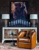 High-quality canvas art print 'Black Bison Framed Print' showcasing a majestic American bison against a stark black background, finished with a matt brushed gel and framed in a sleek black boxed frame, reflecting a blend of western and modern rustic style