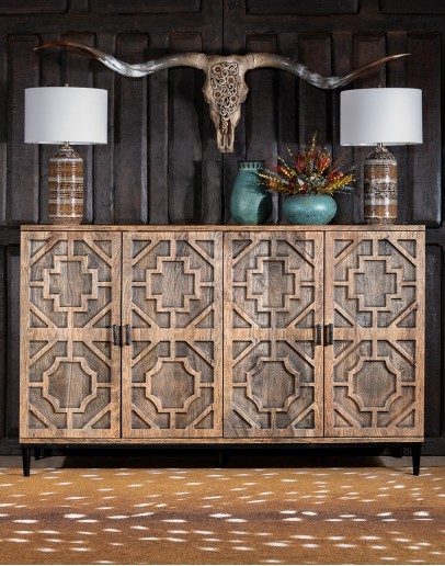 Hex Carved Buffet Image of Mango Solids Entertainment Center with four doors, each featuring an inset geometric carving. The entertainment center has a metal base and is crafted from Mango Solids with a Special Reserve finish and antique brass hardware. It measures 74 inch