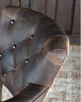 game chair with axis deer hide and brown tufted leather seat cushions