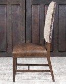 Dining Chair with a solid hardwood frame, top grain leather seat cushion, tweed textured fabric on the inside back, and floral-patterned stamped cowhide on the outer back, adorned with brass nail tacks.