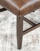 Dining Chair with a solid hardwood frame, top grain leather seat cushion, tweed textured fabric on the inside back, and floral-patterned stamped cowhide on the outer back, adorned with brass nail tacks.