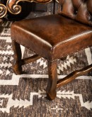 leather dining chair with a button tufted seat back and real axis deer hide