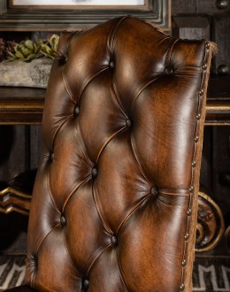 leather dining chair with a button tufted seat back and real axis deer hide