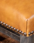 ivory leather chair with boot stitch emblem on seat back