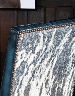 American-made Huckleberry Leather Dining Chair in blue top grain leather with hand-antiqued details, modern rustic frame, and unique hair-on-hide floral pattern on the back.