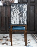 American-made Huckleberry Leather Dining Chair in blue top grain leather with hand-antiqued details, modern rustic frame, and unique hair-on-hide floral pattern on the back.