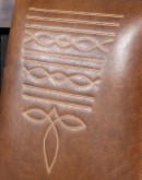 Sundance Saddle Leather Dining Chair featuring solid American Alder Wood frame with black walnut finish, saddle tan leather upholstery, brass nail tacks, and boot stitch emblem.