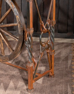 Western-style Pioneer Wagon Wheel Pub Table featuring a solid hand-forged iron base with a detailed wagon wheel design, finished in natural rust and sealed for durability. The top is crafted from distressed Chilean Pine, adding rustic elegance to the piec