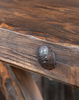 Western-style Pioneer Wagon Wheel Pub Table featuring a solid hand-forged iron base with a detailed wagon wheel design, finished in natural rust and sealed for durability. The top is crafted from distressed Chilean Pine, adding rustic elegance to the piec