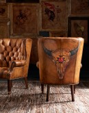 Texas Rose Tufted Leather Chair from the Spirit of the West series, featuring a detailed hand-painted bison skull with Native American petroglyph symbols on luxurious full-grain leather, showcasing artisan Wayne Parmenter's craftsmanship