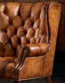 Texas Rose Tufted Leather Chair from the Spirit of the West series, featuring a detailed hand-painted bison skull with Native American petroglyph symbols on luxurious full-grain leather, showcasing artisan Wayne Parmenter's craftsmanship