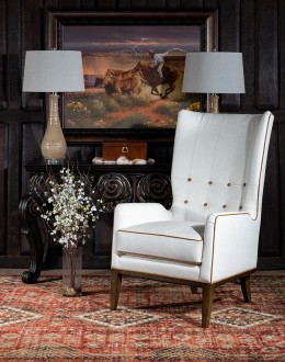 cream leather accent chair with exposed wood frame and contrasting welts