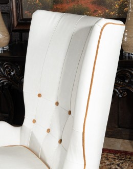 cream leather accent chair with exposed wood frame and contrasting welts