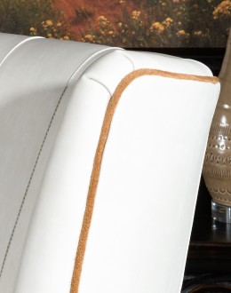 cream leather accent chair with exposed wood frame and contrasting welts