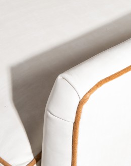 cream leather accent chair with exposed wood frame and contrasting welts