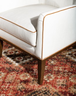 cream leather accent chair with exposed wood frame and contrasting welts