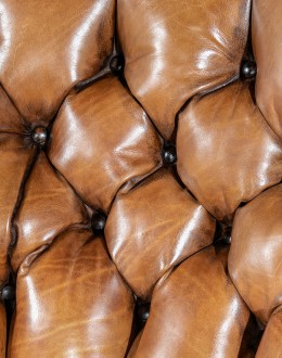 American-made Author Tufted Leather Chair by Remington Tanners, featuring full-grain leather, 8-way hand-tied construction, and deep button tufts, perfect for elegant interiors.