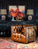 tufted leather club chair with antiqued leather and brindle cowhide on the outside