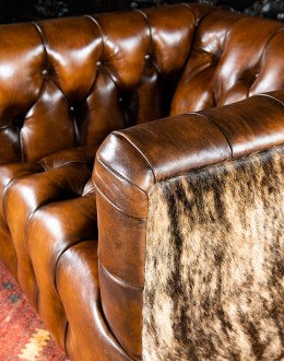 Beretta Club Chair tufted leather club chair with antiqued leather and brindle cowhide on the outside