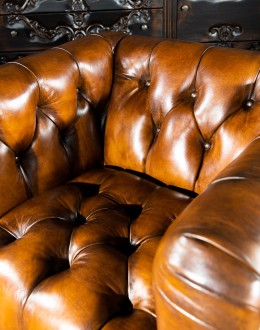 Beretta Club Chair tufted leather club chair with antiqued leather and brindle cowhide on the outside
