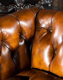 Beretta Club Chair tufted leather club chair with antiqued leather and brindle cowhide on the outside