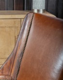 modern rustic leather chair with exposed wood arms