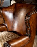 oversized leather wingback chair with a shearling hide seat cushion,saddle leather chair