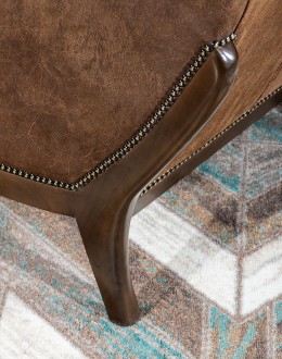 Bronco Blaze Leather Chair Bronco Blaze Leather Chair in distressed chocolate brown, showcasing arched wings, bustle back design, and American-made craftsmanship.