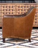 distressed brown leather chair with boot stitch emblem on seat back