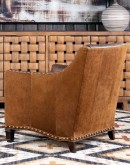 distressed brown leather chair with boot stitch emblem on seat back