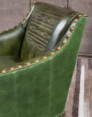 distressed olive color leather chair with boot stitch emblem on seat back