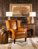 distressed brown leather chair with native American inspired  stitch emblem on seat back