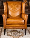 distressed brown leather chair with native American inspired  stitch emblem on seat back