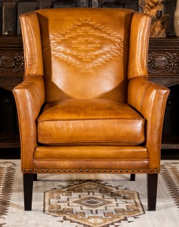 distressed brown leather chair with native American inspired stitch emblem on seat back