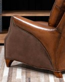 The Cowboy AF Leather Chair is a western-style armchair with a luxurious full-grain leather finish, hand-burnished leather details, and brushed sueded leather accents on the out arms. The chair features plush seat and back cushions, nickel nail trim, and