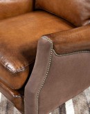 The Cowboy AF Leather Chair is a western-style armchair with a luxurious full-grain leather finish, hand-burnished leather details, and brushed sueded leather accents on the out arms. The chair features plush seat and back cushions, nickel nail trim, and