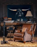 The Cowboy AF Leather Chair is a western-style armchair with a luxurious full-grain leather finish, hand-burnished leather details, and brushed sueded leather accents on the out arms. The chair features plush seat and back cushions, nickel nail trim, and