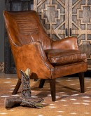 Downtown Cowboy Chair - a small scaled leather accent chair with warm brown, hand burnished leather, cowboy boot stitch emblem on the inside seat back, and a retro-style frame. Expertly crafted in the USA with 8-way hand tied construction, this high-quali