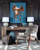 Add rustic charm to your space with this detailed western saddle artwork, set against a serene sky blue background. Framed with a mat back wood frame and coated in a clear semi-gloss epoxy, it ensures vivid colors and lasting protection.