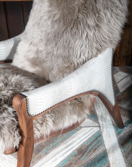 Kodiak Arm Chair American-made Kodiak Arm Chair with solid black walnut frame, crocodile-pattern stamped leather arms, and luxurious Angora hair cushions, accented by nickel nail heads.