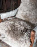 American-made Kodiak Arm Chair with solid black walnut frame, crocodile-pattern stamped leather arms, and luxurious Angora hair cushions, accented by nickel nail heads.