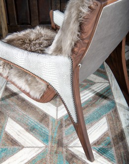 Kodiak Arm Chair American-made Kodiak Arm Chair with solid black walnut frame, crocodile-pattern stamped leather arms, and luxurious Angora hair cushions, accented by nickel nail heads.