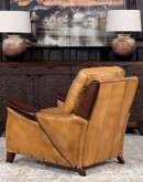 A luxurious Lucky Leather Chair featuring a rich tan full-grain leather upholstery, contrasting leather accents on the arms, brass nail tacks, and a unique leather horseshoe detail.